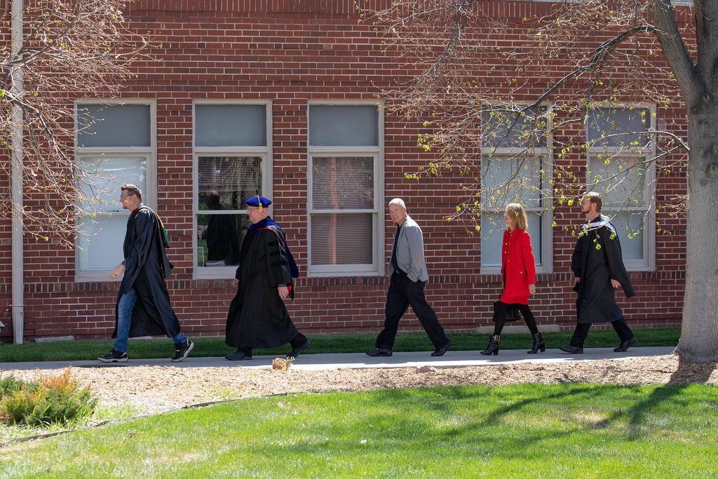 Ellen Bruss walking fourth in line to the keynote speech at the RMCAD graduation.