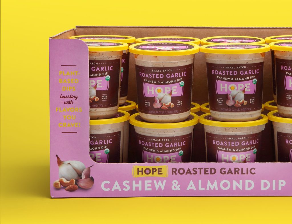 A box of Hope Roasted Garlic Cashew & Almond Dip containers designed by EBD.