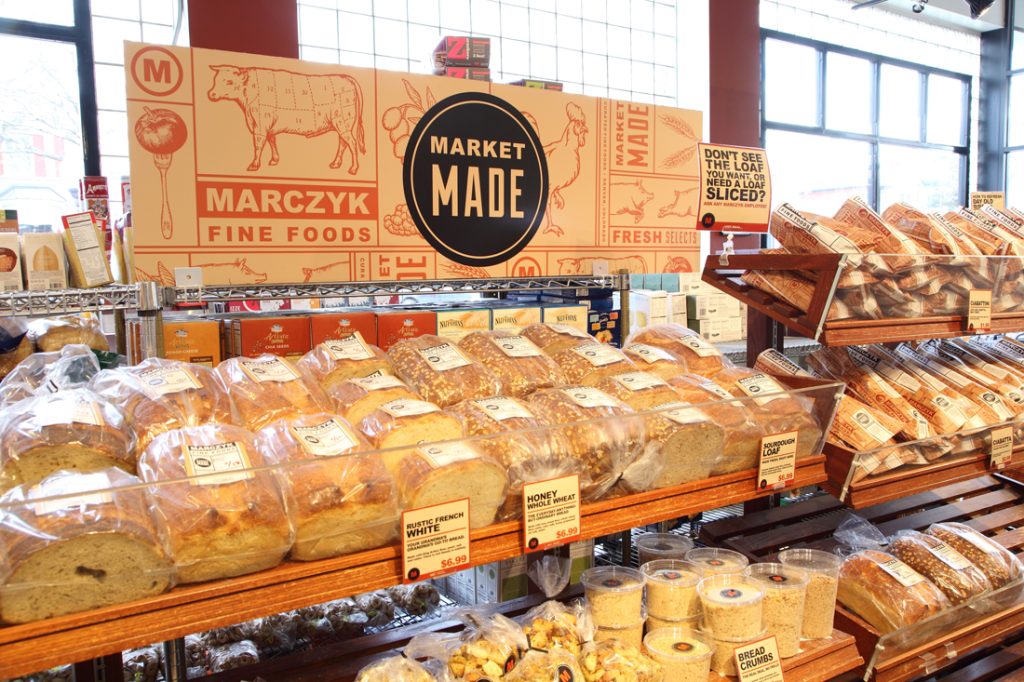 Interior signage for Marczyk designed by EBD over shelves of bread.