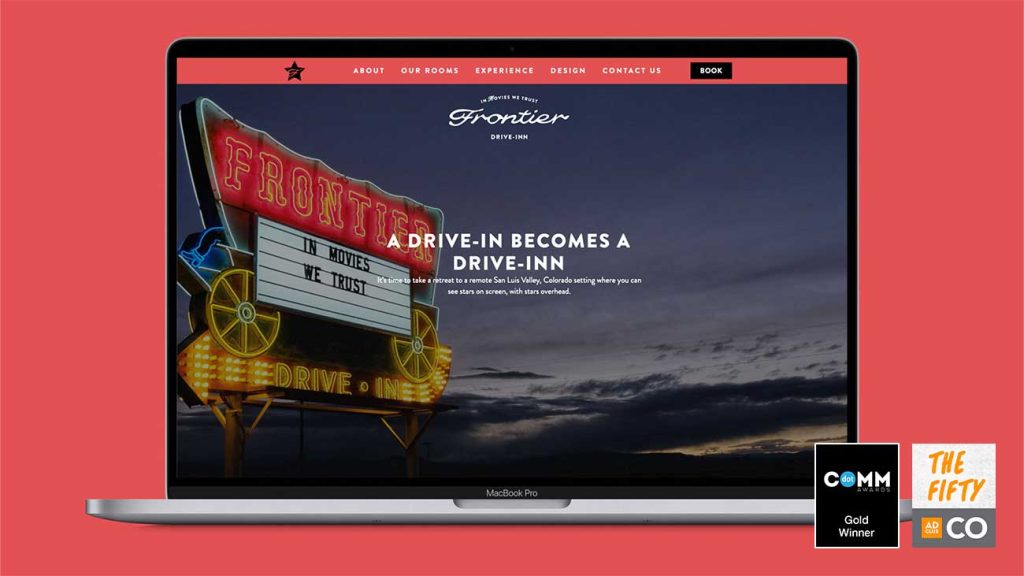 A mockup of the Frontier Drive-Inn website homepage with an image of a neon sign that says "In Movies We Trust".