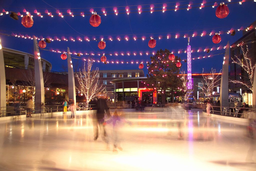 Ice skating under holidya lights at Belmar Shopping District in Lakewood, Colorado.